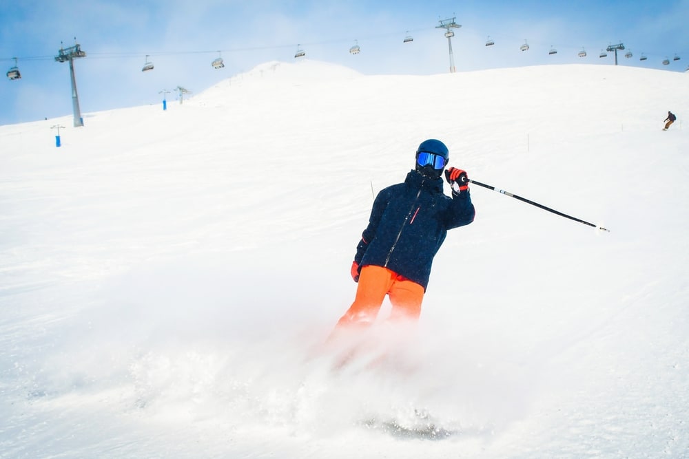 things to do in oregon this winter, man skiing at mountain resort