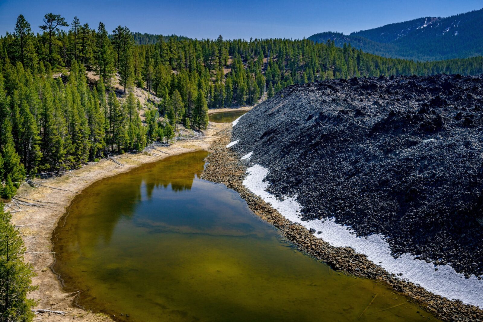 Don't Miss the Newberry National Volcanic Monument 1 Small lake at the edge of a lava flow in Newberry National Volcanic Monument